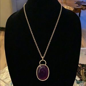 Brand new gold color necklace with purple stone
